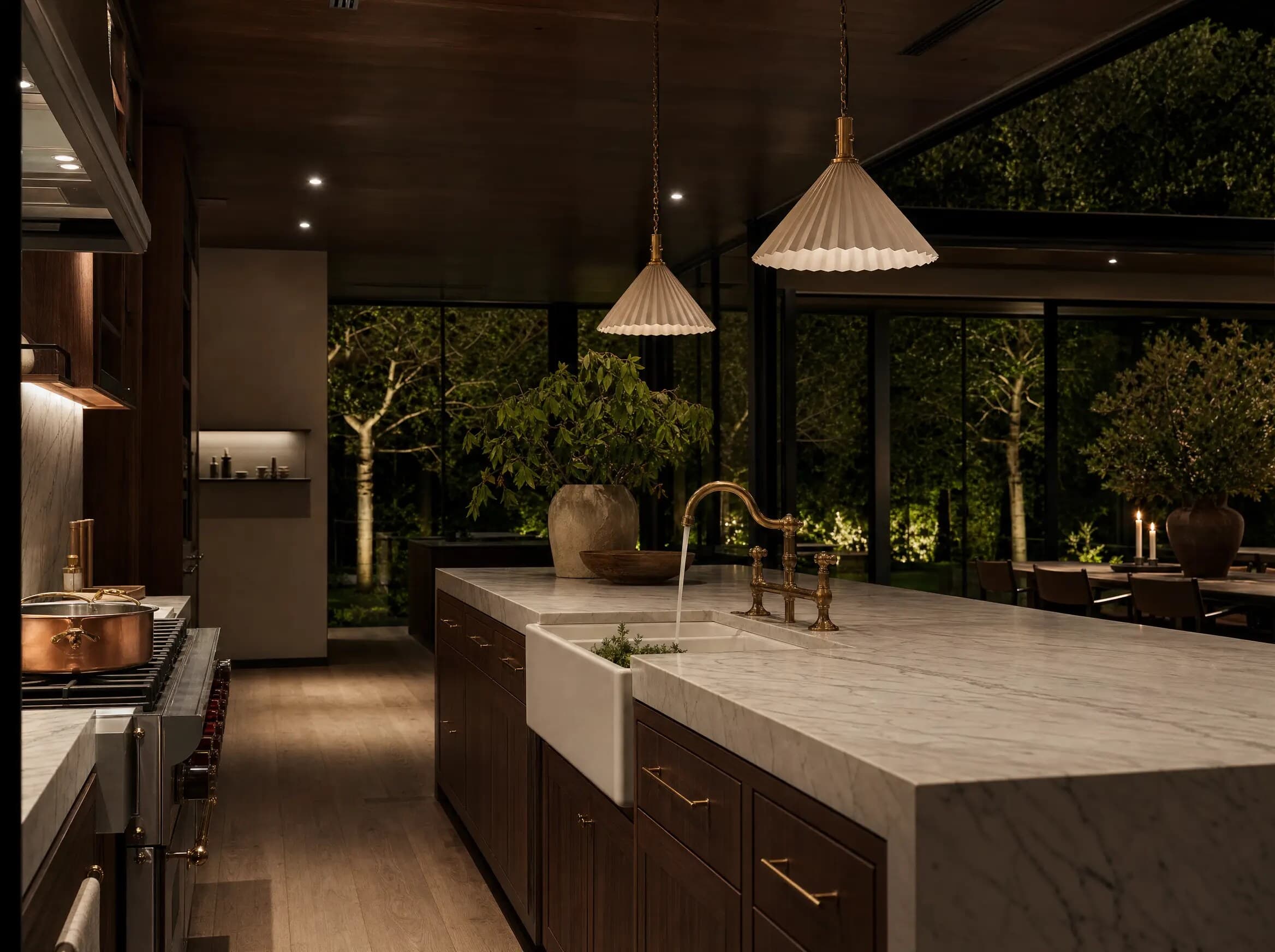 Kitchen with a brass bridge faucet over a marble island